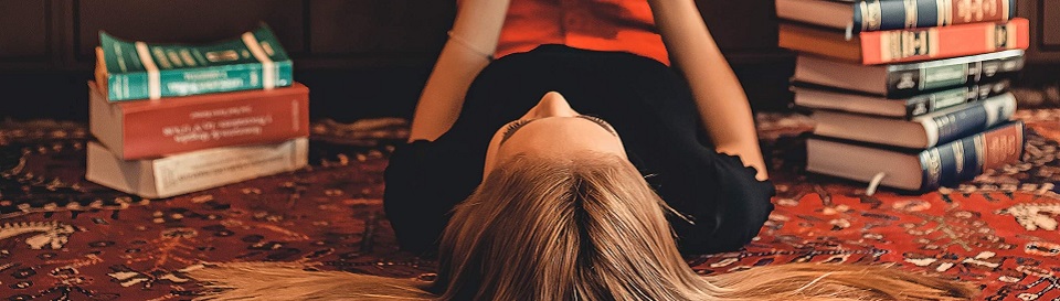 woman lying on area rug reading books 2899918